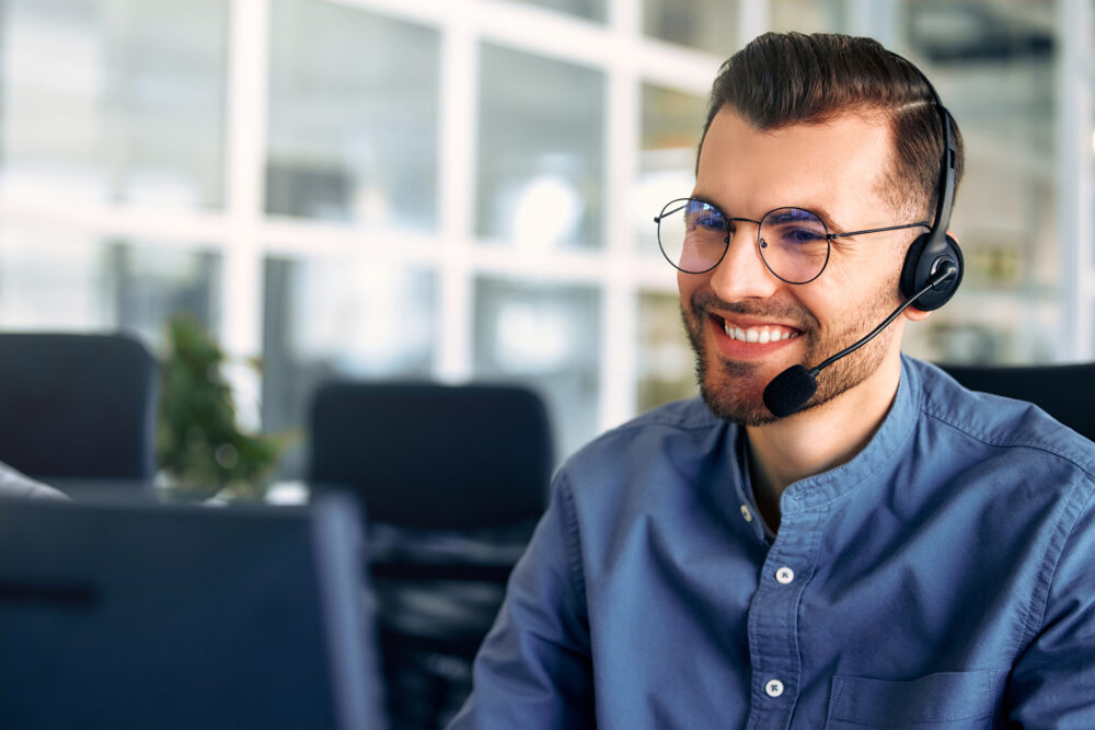 Happy call centre agent dealing with a customer